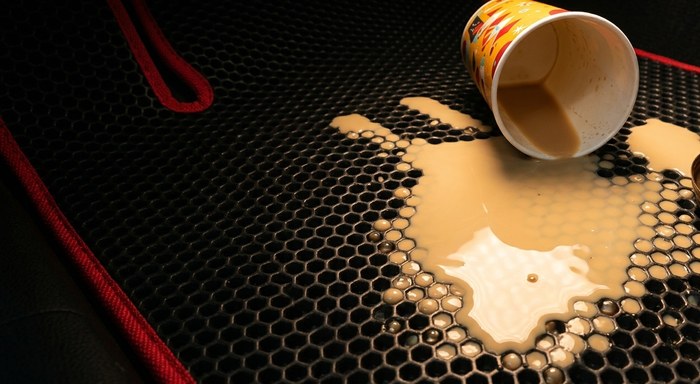 Spilled coffee contained by an EVAMATS car mat